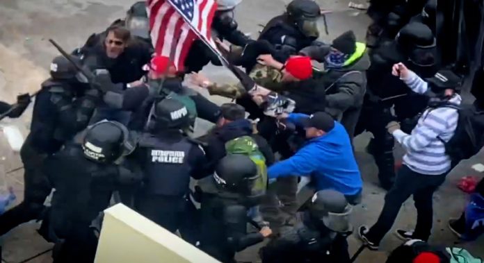 50745475-9034-44ee-b96b-121f5cf219b9-VPC_CAP_RIOTERS_THROW_FIRE_EXTINGUISHER_wide_storyful